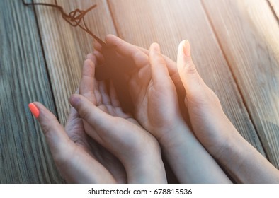 Mother And Son Praying Together And Holding Old Wooden Rosary. Family Prayer