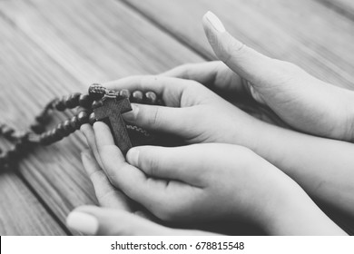 Mother And Son Praying Together And Holding Old Wooden Rosary. Family Prayer