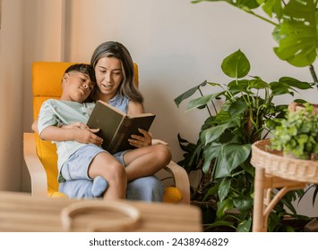 A mother and son share a peaceful moment reading a book. - Powered by Shutterstock