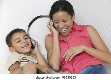 Mother And Son Sharing Headphones