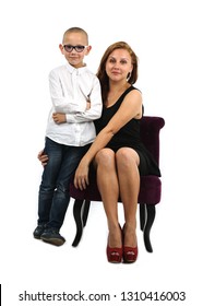 Mother And Son Sitting Down On A Chair Against A White Background