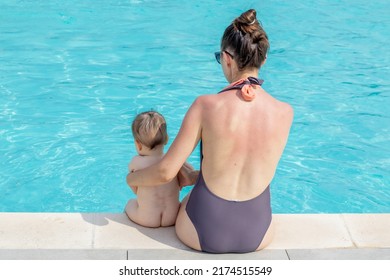Mother And Son Sitting On Pool Edge.naked Toddler With But On Floor And Mother Wearing Sexy Swimsuit.mom Have Sunburned Back.vacation With Kids Concept