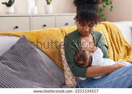 Similar – Image, Stock Photo Mother breast feeding and hugging her baby boy outdoors.