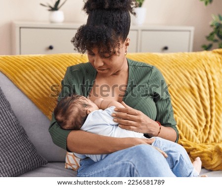 Image, Stock Photo Mother breast feeding and hugging her baby boy outdoors.