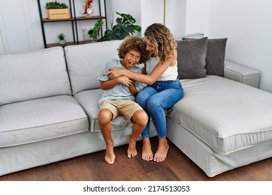 Mother and son smiling confident make tickle at home