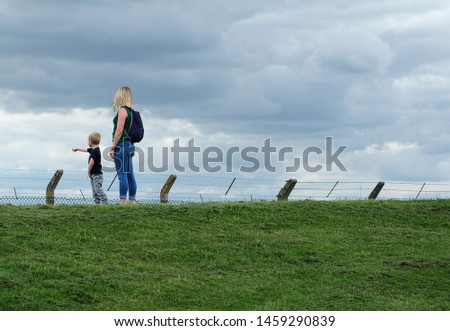 Mother and son standing stil outdoors