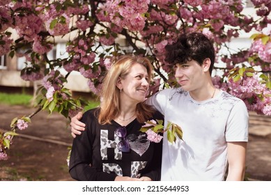 Mother And Son Talking In Spring In The Park And Cutely Looking At Each Other And Smiling, Mother Encouraging Her Teenage Son