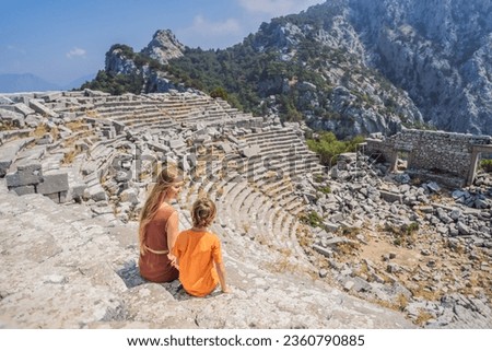 mother and son tourists explores Stunning Ancient Theater of Termessos Ancient City. Traveling with kids concept. turkiye, GO Everywhere