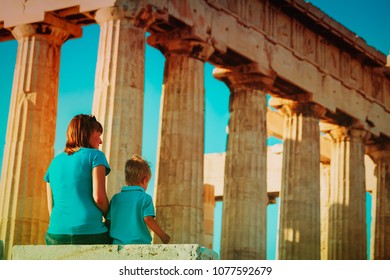 Mother And Son Travel In Greece, Lookint At Ancient Buildings