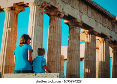 Mother And Son Travel In Greece, Lookint At Ancient Buildings