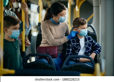 Mother and son traveling by bus with precautionary measures during coronavirus pandemic - Powered by Shutterstock