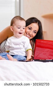 Mother And Son Are Using Laptop At Home