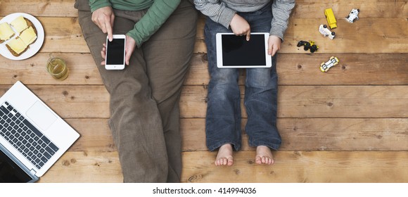 Mother and son using tablet and laptop