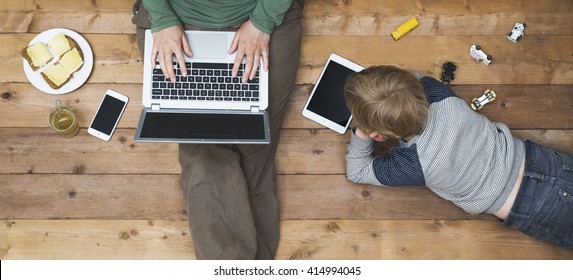 Mother and son using tablet and laptop - Powered by Shutterstock