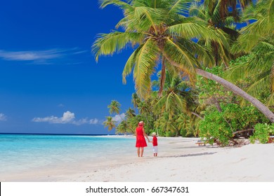 Mother And Son Walking On Beach