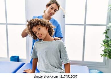 Mother and son wearing physiotherapist uniform having rehab session stretching neck at physiotherapy clinic - Powered by Shutterstock