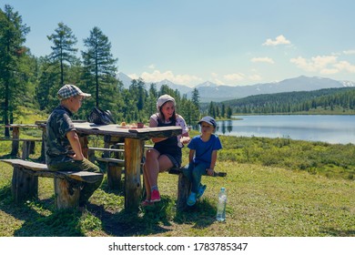 Mother and sons eating in the mountains - Powered by Shutterstock