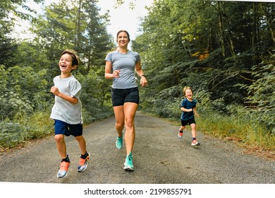 A mother and sons running outside in forest - Powered by Shutterstock