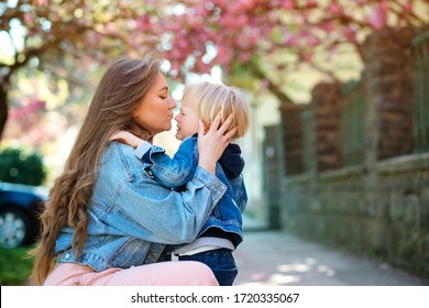 Mother Soothing Her Sad Child Outdoors. Mom With Upset Baby On A Walk At Spring. Toddler Boy Crying At Street. Motherhood, Family And Lifestyle. Family Outdoors. Mother Hugging Her Sad Son.