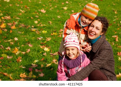 mother with?daughter and?son in sunny autumnal park