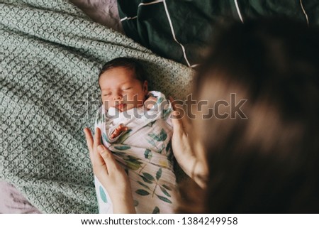 Similar – Image, Stock Photo Mother hugging her baby in front of fireplace