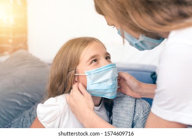 mother take care for her daughter in medical mask. recovery from illness - Powered by Shutterstock