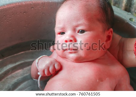 Similar – Newborn in the bathtub with her mother washing her hair