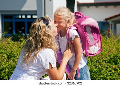 Mother taking her daughter to school, saying her goodbye for the day