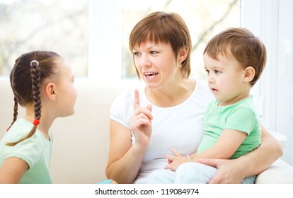 Mother talking to her children, indoor shoot