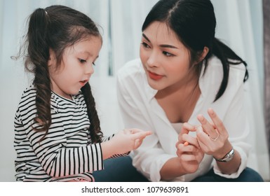 Mother Teach Daughter Counting Numbers Finger, Parent And Kid Education Preschool Or Kindergarten Tutor At Home Family Lifestyle.