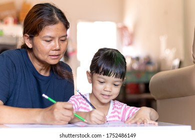 The mother was teaching her daughter to study. In the period of Covid 19, it was necessary to study at home. Mother taught her daughter to study at home happily, with smiling faces.