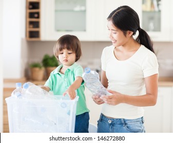 A mother teaching her little boy about the importance of recycling. - Powered by Shutterstock