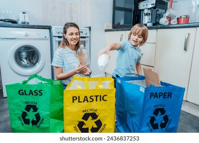 Mother is teaching kid how to recycle help the boy aware environmental importance - mom educates son sort garbage into different bins on kitchen. Family sorting garbage at home. Concept of recycling. - Powered by Shutterstock