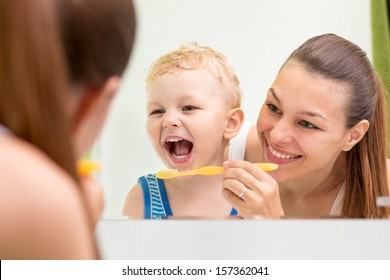 mother teaching kid teeth brushing - Powered by Shutterstock