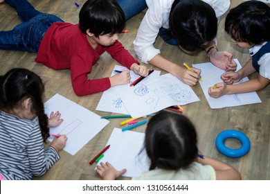 Mother Teaching Kids Drowing Cartoon In Living Room,pre School Concept