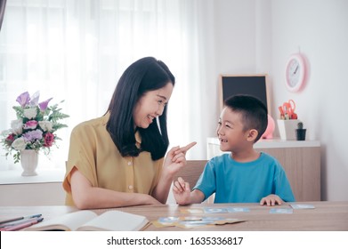 Mother Teaching Math Number Her Son At Home.Family Love And Education Concept