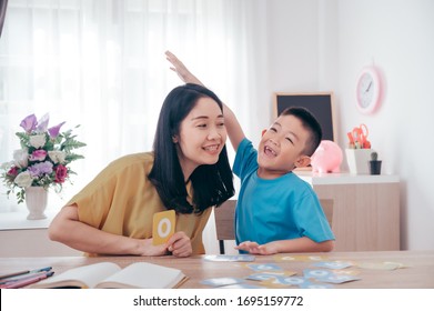 Mother Teaching Math Number Her Son At Home.Family Love And Education Concept