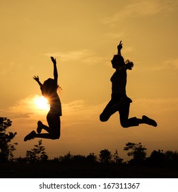 Mother And Teen Daughter Jumping On The Nature