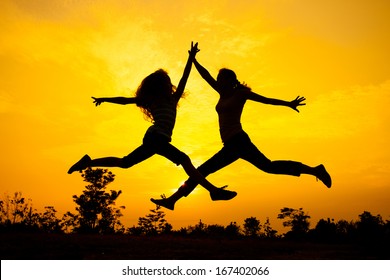 Mother And Teen Daughter Jumping On The Nature