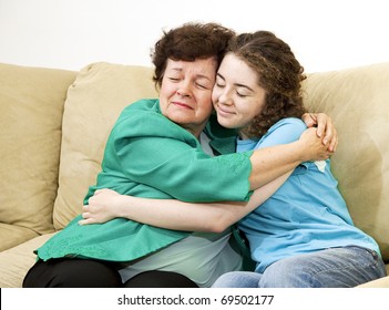 Mother And Teenage Daughter Giving Each Other A Big Hug.