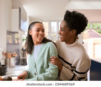 Mother With Teenage Daughter Helping To Prepare Meal At Home In Kitchen Together - Powered by Shutterstock