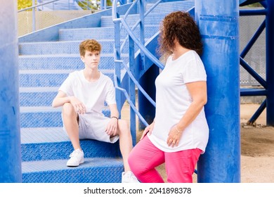 Mother And Teenage Son Talking On The Street