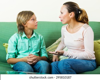 Mother With  Teenager Son Having Serious Conversation In Home 