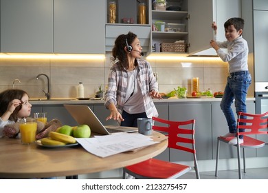 Mother Telling Son To Stop Slamming Door Of Cupboard