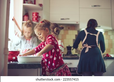 Mother With Three Kids Cooking Holiday Pie In The Kitchen, Casual Lifestyle Photo Series In Real Life Interior