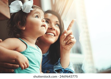 Mother, toddler and happy or home window, love and bonding with family in apartment together with girl baby. Childhood development, growth and smile or caring, woman and hand pointing in house - Powered by Shutterstock