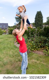 Mother Tossing Baby In The Air - NRW, Germany