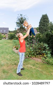 Mother Tossing Baby In The Air - NRW, Germany