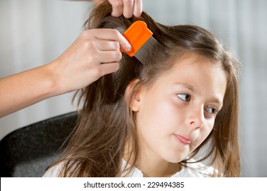 Mother Treating Daughter's Hair Against Lice