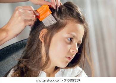 Mother Treating Daughter's Hair Against Lice